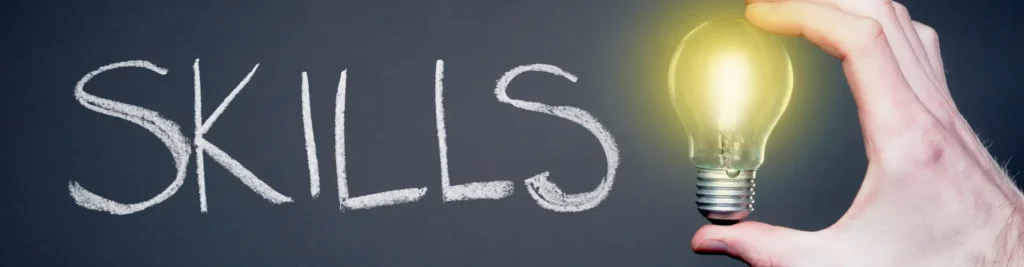 Word SKILLS with glowing light bulb symbolizing ideas and career growth.